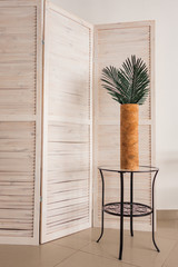 Stylish office decoration with tropical leaves