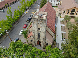 Aerial view of St. Helena Roman Catholic Church, historic church building in St. Helena, Napa Valley, California, USA. Built from 1889 to 1890, the church was constructed with stone, a common building