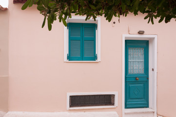 Fototapeta na wymiar The door and window on the street of the Anafiotika district near the Acropolis in the city of Athens, Greece