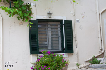 Fototapeta na wymiar The window on the street of the Anafiotika district near the Acropolis in the city of Athens, Greece