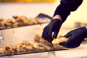 Chef in gloves in process of preparation meal