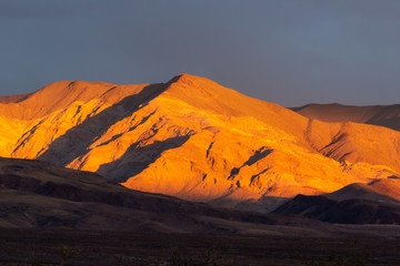 Sunrise in Death Valley mountains near mesquite dunes. California, USA