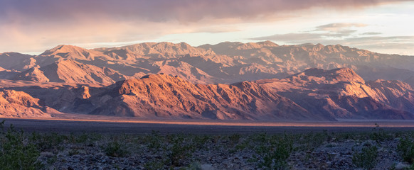 Sunrise in Death Valley mountains near mesquite dunes. California, USA