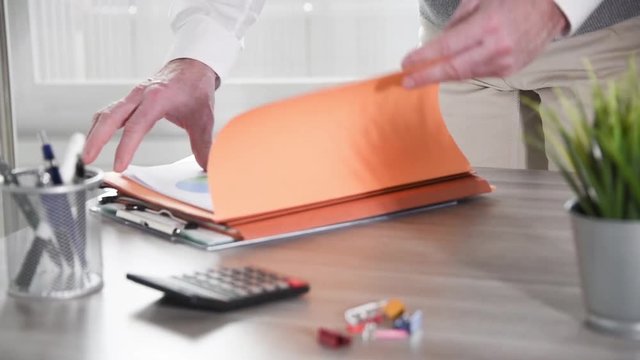 Businessman searching for a document in folders