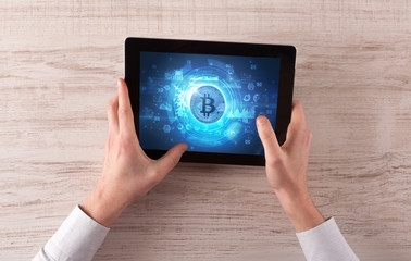 Hand working on tablet with cryptocurrency and network concept
