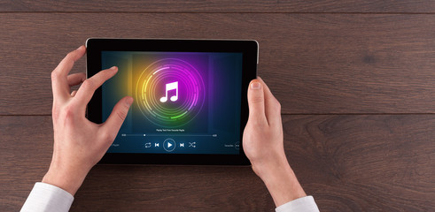 Hand touching tablet with music play  concept
