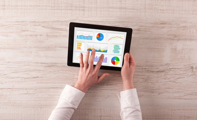 Hand making diagrams and charts on tablet