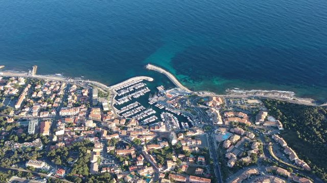 Aerial shot flying towards Sausset les Pins residential area coastal mediterranean city France sunset summer