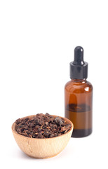 Bowl of Myrrh with a Bottle of Essential Oil on a White Background