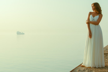 Fototapeta na wymiar Girl in white by the sea