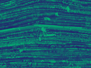 Vibrant background texture made from piles of cloth with a colorful green and blue duotone overlay