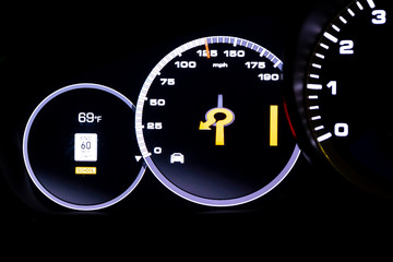 Modern light car mileage on black background