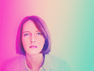 Portrait of young woman looking at the viewer. Neon colors. Copy space.