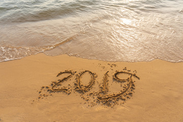 Happy New Year 2019 on golden sand beach