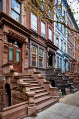 a view of a row of historic brownstones in an iconic neighborhood of Manhattan, New York City