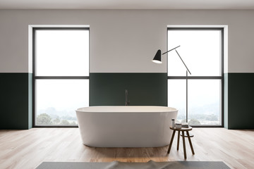 Fototapeta na wymiar Green and white bathroom, windows and tub
