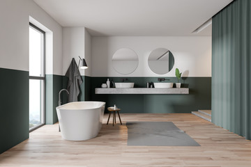 Fototapeta na wymiar Green and white bathroom, tub and sink
