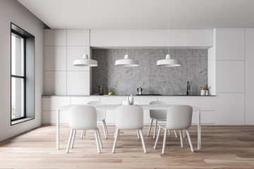 White kitchen with countertops and table
