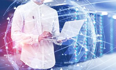 Man with laptop in server room, network concept