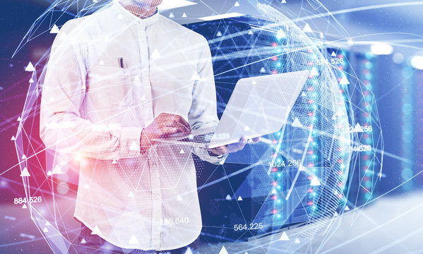 Man with laptop in server room, network concept
