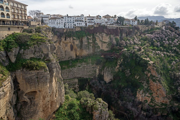 Fototapeta na wymiar City of Ronda in the Spanish province of Malaga in Andalusia. Beautiful view of the mountains, the observation deck and the valley. Gorge