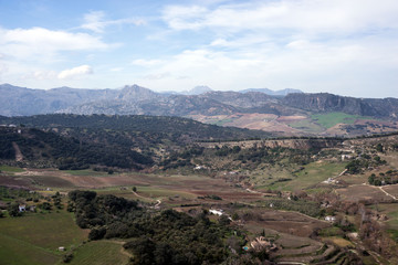 Obraz premium Beautiful city on top of a mountain in the Spanish province of Malaga in Andalusia. View of the valley. Tourists admire the scenery.