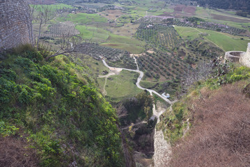 Obraz premium Beautiful city on top of a mountain in the Spanish province of Malaga in Andalusia. View of the valley. Tourists admire the scenery.