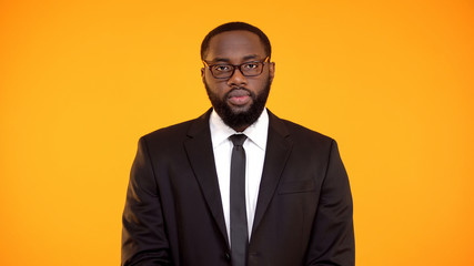 Determined african-american male in suit looking to camera, department leader