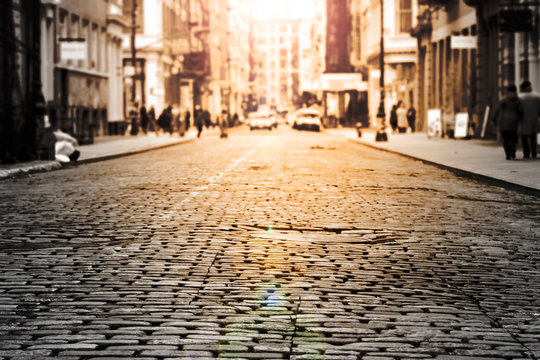 Fototapeta New York City - Cobblestone street view in Soho with sunlight background in black and white