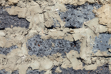 Close-up background on cinder blocks and cement bricks at a construction site with poor quality masonry in an old building. Ruins and ancient architecture
