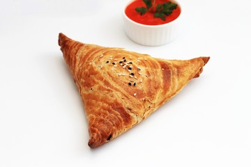 Samosa and sauce on white background, Eastern food.