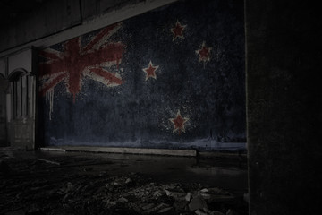 painted flag of new zealand on the dirty old wall in an abandoned ruined house