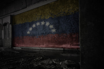 painted flag of venezuela on the dirty old wall in an abandoned ruined house