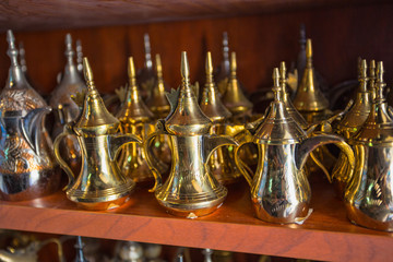 Fototapeta na wymiar row of shiny traditional coffee pots and lamp