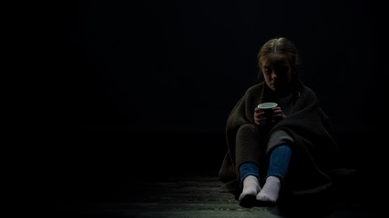 Female kid holding beggar cup, checking donation, charity, homeless children