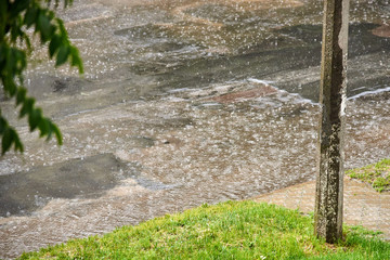 Asphalt road with holes during heavy rain on a summer day. Theme safety on the road.