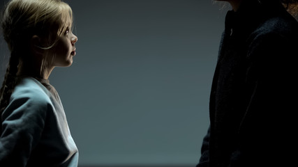 Little girl looking at adult woman, orphan child finding mother, togetherness
