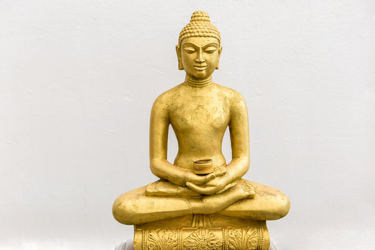 Buddha statue on the white wall background