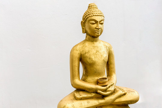 Buddha statue on the white wall background