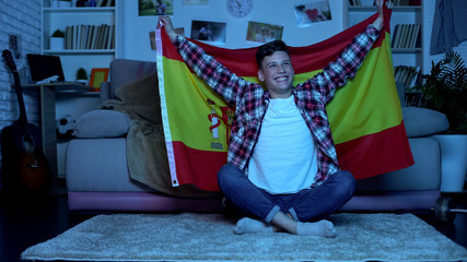 Teenager with Spanish flag supporting national football team, championship