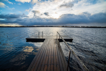 Fototapeta premium clear sky with dramatic clouds over the lake in sunset