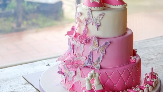 fist cake for a little baby girl birthday celebrating baptism 4k pink sugarpaste layered cake design no people - Powered by Adobe