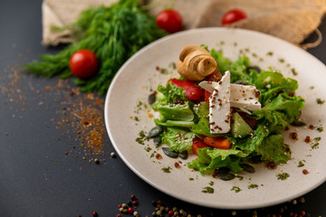 Greek salad of fresh cucumber, tomato, sweet pepper, lettuce, red onion, feta cheese and olives with olive oil. Healthy food, top view. Black background . Slow-mo.
