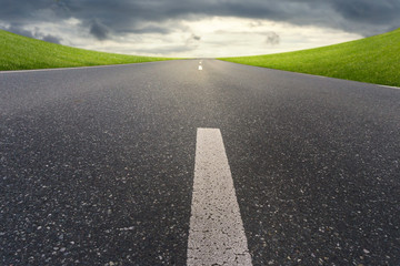 road and dark cloudy sky