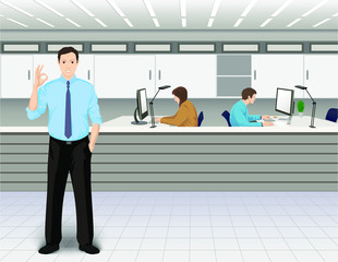 Office interior. Young man shows the OK gesture. Co-workers on the background near the own computers.