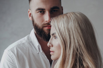 girl blonde and a guy with a beard