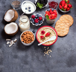 Healthy vegan breakfast with coconut yogurt, muesli, chia pudding, crisp bread, nuts, berries. Balanced diet and healthy eating concept