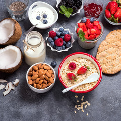 Healthy vegan breakfast with coconut yogurt, muesli, chia pudding, crisp bread, almonds, berries. Balanced diet and healthy eating concept