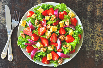 Salad with strawberries, blue onions, walnuts and garganzola cheese. Healthy strawberry salad. Keto diet.
