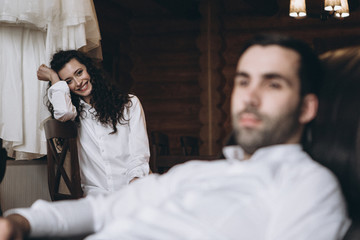 Fototapeta premium selective focus bride, husband and wife in the morning before the wedding in a large wooden house dressed in white shirts